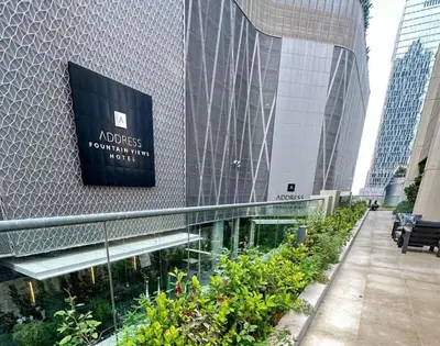 a building with a sign on the side of it at Dunya Tower Royal suites in Dubai