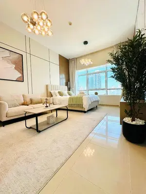 a living room with a couch and a table at Lake City Tower in Dubai