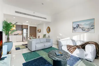 a living room with a couch and a table at Fendi 1BR with Panoramic Sea View in Dubai