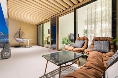 a living room with two couches and a table at Fendi 1BR with Panoramic Sea View in Dubai