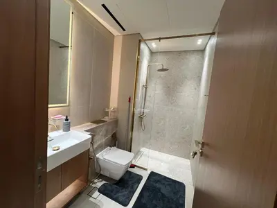 a bathroom with a toilet and a sink and a shower at Luxury - Burj Khalifa View - Private Jacuzzi in Dubai