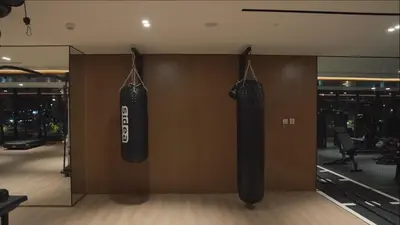a gym with two black punching bags hanging on a wall at Luxury - Burj Khalifa View - Private Jacuzzi in Dubai