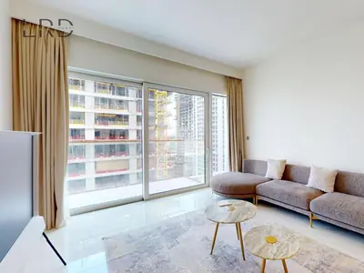 a living room with a couch and a large window at Waterfront 1 Bedroom Apartment - Private Beach - Emaar Beachfront in Dubai