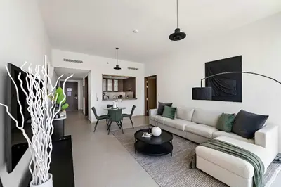 a living room with a couch and a table at Silkhaus Serene 1BR at Boulevard Heights in Downtown in Dubai