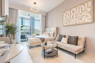 a living room with a bed and a couch at Near Dubai Miracle Garden Studio with Community Views Balcony, Legacy by Sunrise, Arjan-Dubailand by Deluxe Holiday Homes in Dubai