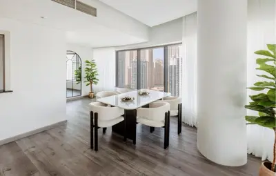 a dining room with white walls and a table and chairs at Beautiful 3 bed In Dubai Marina! in Dubai