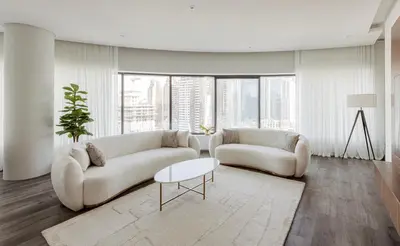 a living room with two couches and a table at Beautiful 3 bed In Dubai Marina! in Dubai