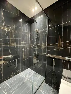 a bathroom with a shower with a glass door at Modern & Smart 1br W Stylish Interiors In Jvc in Dubai