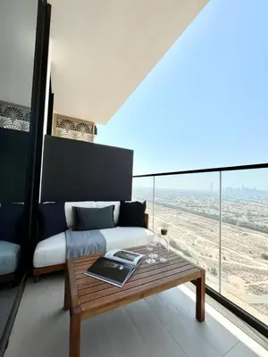 a living room with a couch and a table at Modern & Smart 1br W Stylish Interiors In Jvc in Dubai