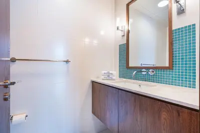 a bathroom with a sink and a mirror at Palm Home next to Nakheel Mall with Private Beach in Dubai