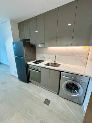 a kitchen with a sink and a washing machine at Dubai - Brand New Apartment in Dubai