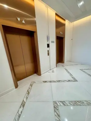 a hallway with doors and tile floors in a building at Dubai - Brand New Apartment in Dubai
