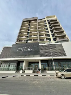a large building with a sign on the side of it at Dubai - Brand New Apartment in Dubai