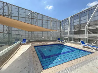 a swimming pool on the side of a building at Premium & Cozy Home in the Heart of Sports City in Dubai