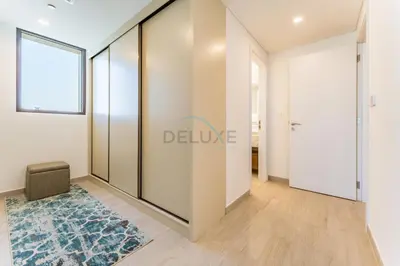 a room with a sliding glass door and a rug at 2BR with Balcony, Exclusive Amenities and Steps from Iconic Landmarks, Madinat Jumeirah Living Rahaal 2, Jumeirah in Dubai