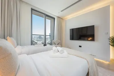 a hotel room with two beds and a tv at StayShort - Sleek Studio in The Ivy Tower, JVT in Dubai