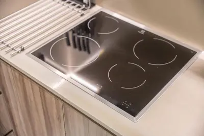 a stove top oven sitting on top of a cabinet at StayShort - Sleek Studio in The Ivy Tower, JVT in Dubai