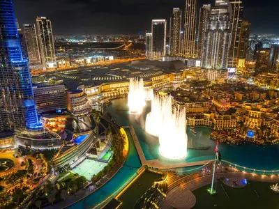 a view of a city at night with a fountain at Crown Jewel 2 Bedroom Apartments I Iconic Burj Khalifa and Fountain Views I Free Parking, Gym, Pool, Wi-Fi and PS5 I by Skyline Serenity in Dubai
