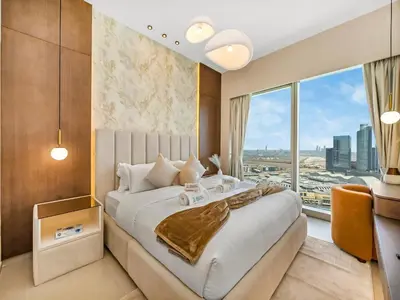 a bedroom with a large bed and a large window at Crown Jewel 2 Bedroom Apartments I Iconic Burj Khalifa and Fountain Views I Free Parking, Gym, Pool, Wi-Fi and PS5 I by Skyline Serenity in Dubai