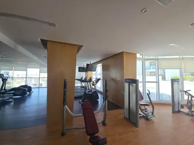 a gym with treadmills and exercise equipment in a building at EasyGo- Sleek Studio at Damac Hills Artesia D in Dubai
