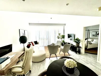 a living room with a couch and chairs and a table at The Pad by Omniyat in Dubai