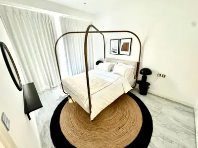 a bedroom with a bed with a metal frame at The Pad by Omniyat in Dubai
