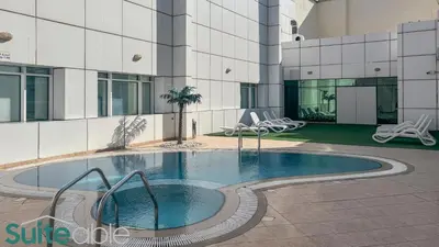 a swimming pool in the middle of a building at Stylish 1 Bedroom near metro station in JLT in Dubai