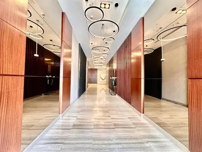 a hallway in a building with wood paneling and a hallwayngth at Modern 2BR Skyline & Marina View in Dubai