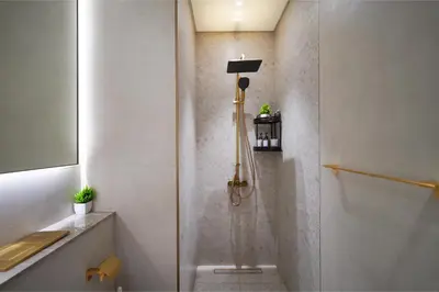 a shower stall in a bathroom with a sink at PurityStaysDXB in Dubai