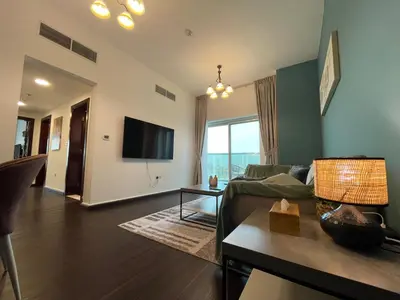 a living room with a couch and a tv at Ultra Luxury Chic 2Bed in Dubai in Dubai