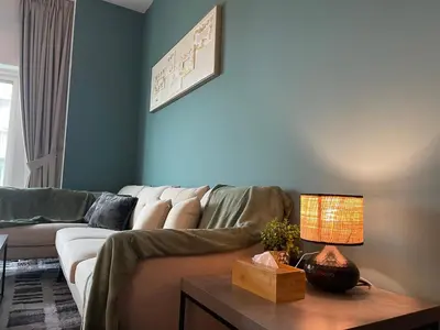 a living room with a couch and a table with a lamp at Ultra Luxury Chic 2Bed in Dubai in Dubai