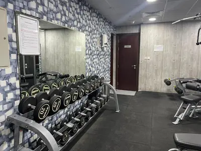 a gym with a rack of dumbbells in a room at Ultra Luxury Chic 2Bed in Dubai in Dubai