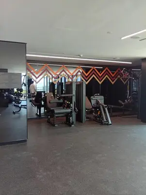 a room with a gym with chairs and a wall at Luxury 2BR Apartment in Urban Oasis by Missoni in Dubai