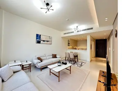 a living room with a couch and a table at Elegant 1-Bedroom Apartment in Dubai Silicon Oasis - by Alphatel Vacations in Dubai