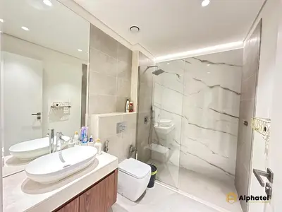 a bathroom with a sink and a toilet and a shower at Elegant 1-Bedroom Apartment in Dubai Silicon Oasis - by Alphatel Vacations in Dubai