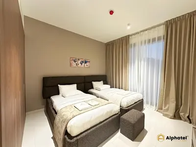 a bedroom with two beds and a window at Elegant 1-Bedroom Apartment in Dubai Silicon Oasis - by Alphatel Vacations in Dubai