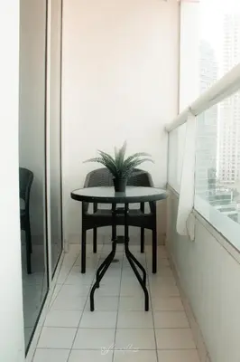 a table with a plant on it in a room at LivWithUs - 2 BR in Marina View Tower B in Dubai