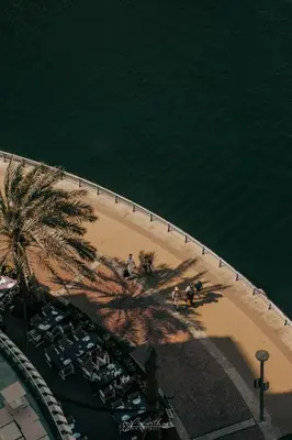 an overhead view of a beach with chairs and palm trees at LivWithUs - 2 BR in Marina View Tower B in Dubai
