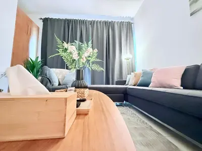 a living room with a blue couch and a table at LivWithUs - 2 BR in Marina View Tower B in Dubai