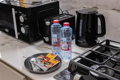 two bottles of water sitting on a kitchen counter at Modern Studio Apartment JVC in Dubai