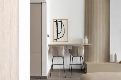 a bedroom with two chairs and a table in a room at Modern Studio Apartment JVC in Dubai