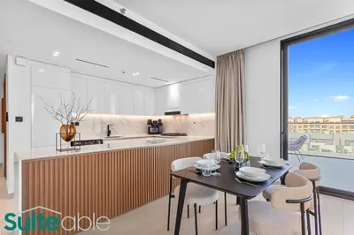a kitchen and dining room with a table and chairs at Sophisticated 1 Bedroom in Binghatti Galaxy JVC in Dubai