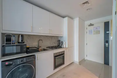 a kitchen with a stove and a dishwasher at Central Apartment in Dubai Heart in Dubai