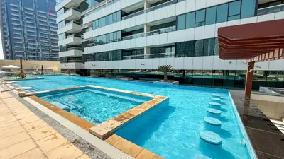 a large swimming pool in front of a building at Central Apartment in Dubai Heart in Dubai