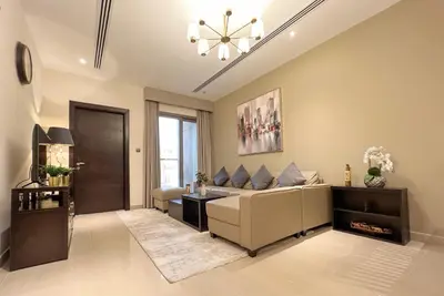 a living room with a couch and a table at 1BDR with Burj Khalifa Views in Elite Downtown in Dubai