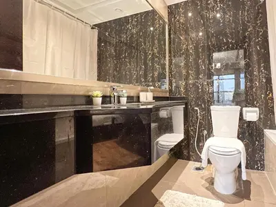 a bathroom with a toilet and a sink at 1BDR with Burj Khalifa Views in Elite Downtown in Dubai