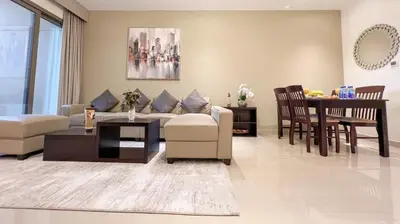 a living room with a couch and a table at 1BDR with Burj Khalifa Views in Elite Downtown in Dubai