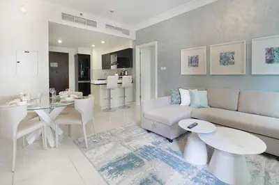 a living room with a couch and a table at EasyGo - Chic 1BR in Damac Maison in Dubai