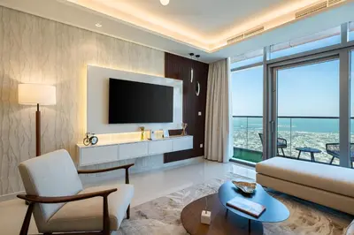 a living room with a couch and a tv at 3 Bedroom - Pool Access - 7 mins to Dubai Mall - Sun Set View in Dubai