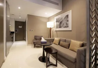 a living room with a couch and a table at Burj Khalifa & Canal View LuxeStudio in DAMACPrive in Dubai